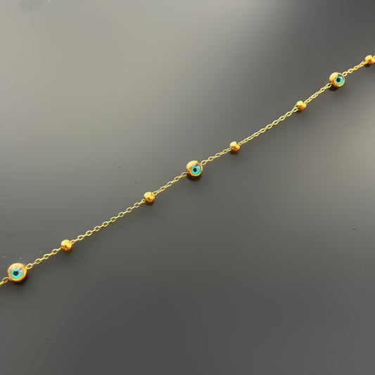 Chevillère oeils ronds  et perles dorées